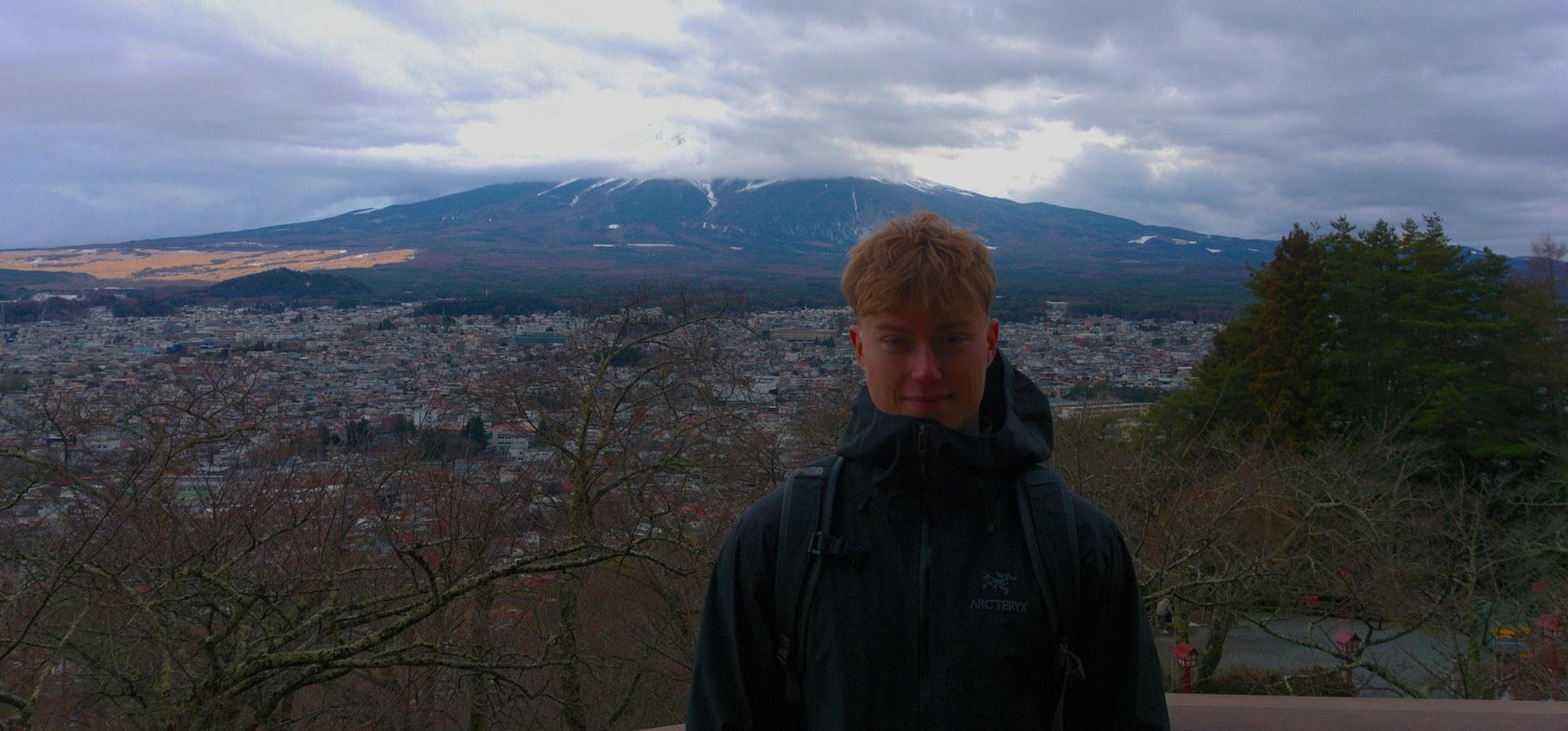 Lewis standing in front of Mount Fuji